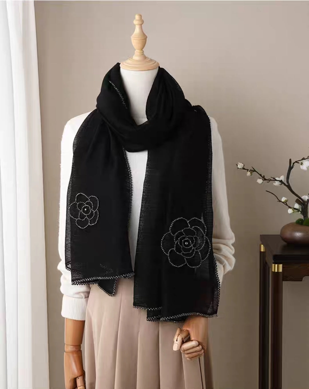 Black camellia embroidered silk-wool shawl with delicate beaded trim.

