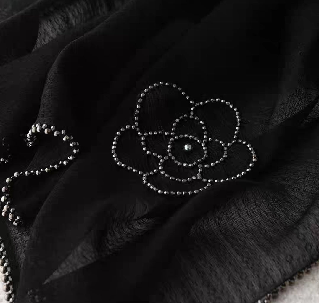 Romantic silk-wool blend shawl with intricate hand-beading and floral patterns.

