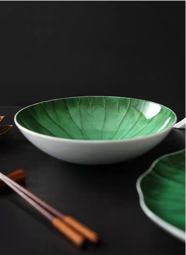 Close-up of textured lotus leaf pattern on ceramic platter, restaurant style.

