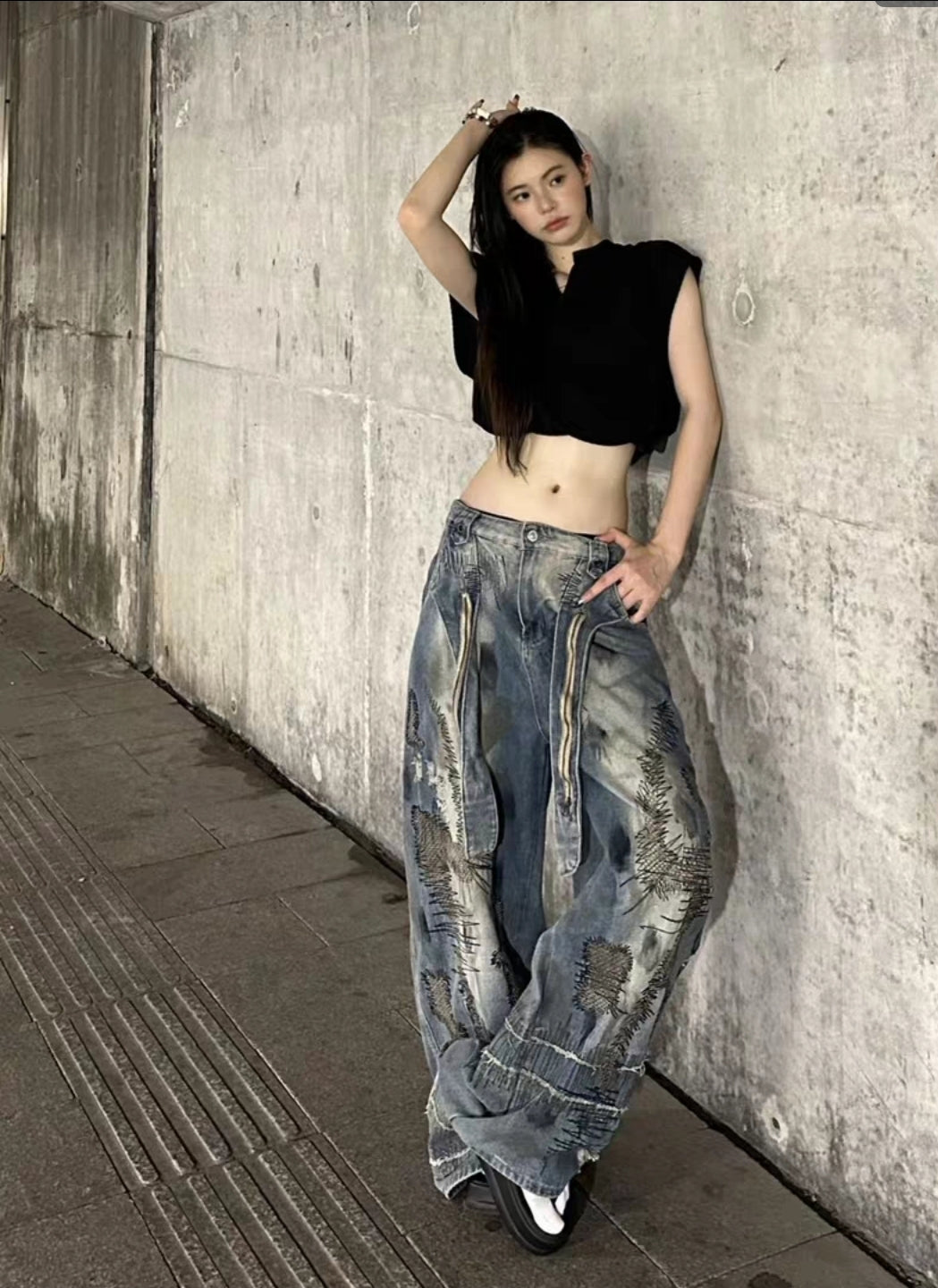 odel wearing distressed grunge baggy jeans with red top

